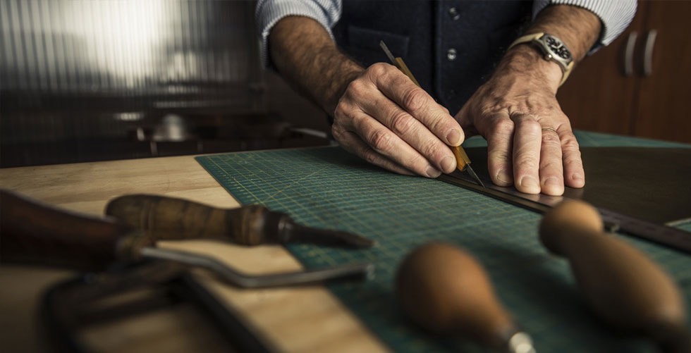 Craftsman working with leather